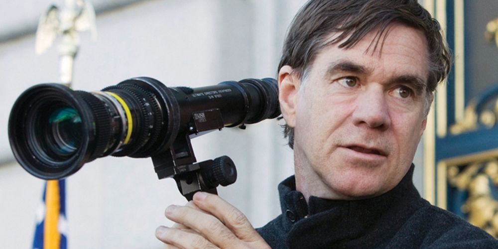 Gus Van Sant holds up a camera lens