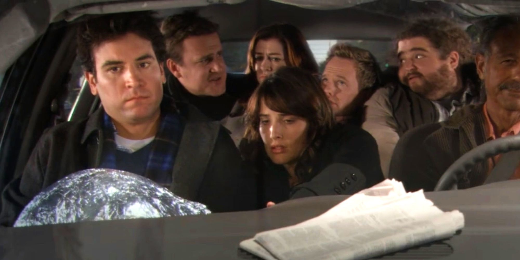 The main cast of How I Met Your mother squeezed into a cab with the driver and Jorge Garcia
