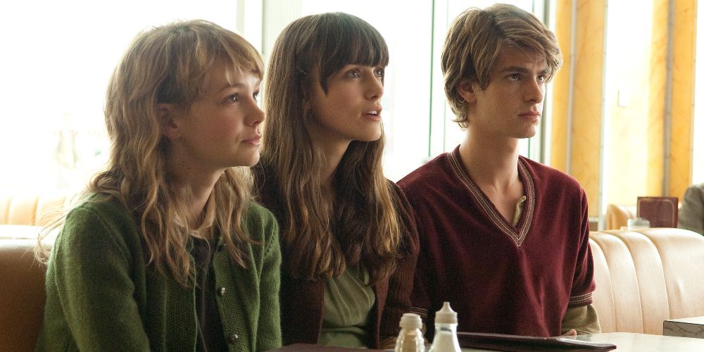 Kathy, Ruth, and Tommy sit at a diner table in Never Let Me Go