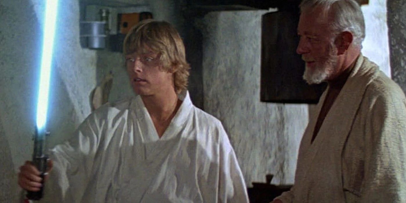 Luke holds Anakin's lightsaber in A New Hope with Obi-Wan looking on