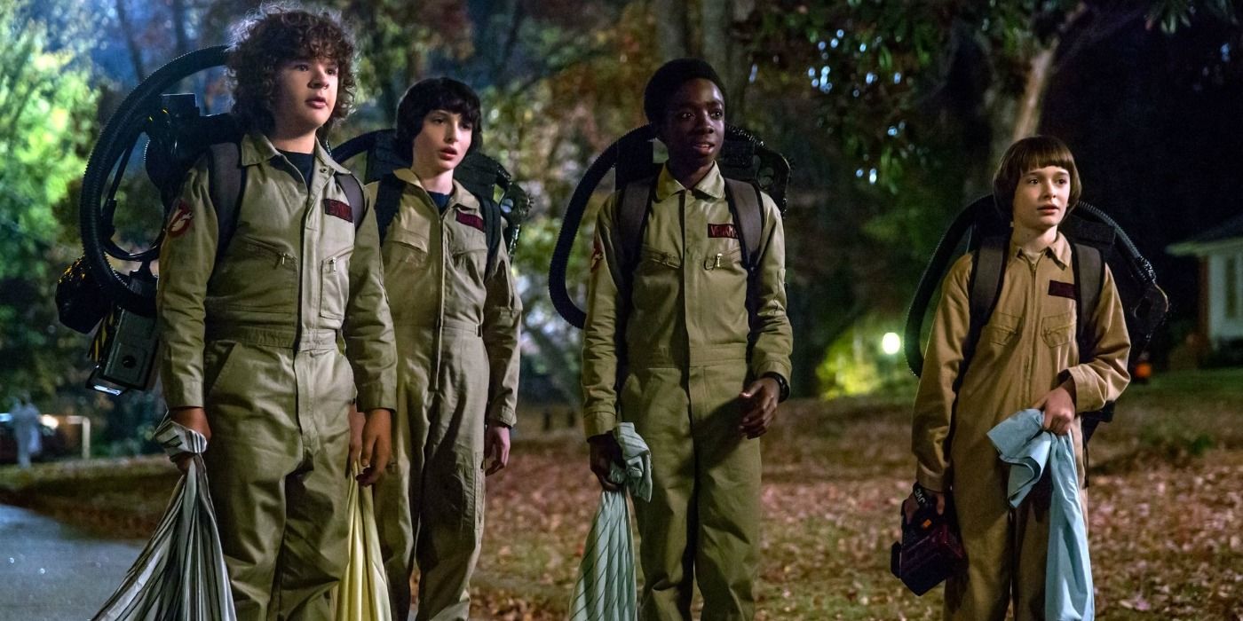 Mike, Dustin, Caleb, and Will wearing Ghostbusters Halloween costumes trick or treating on Stranger Things