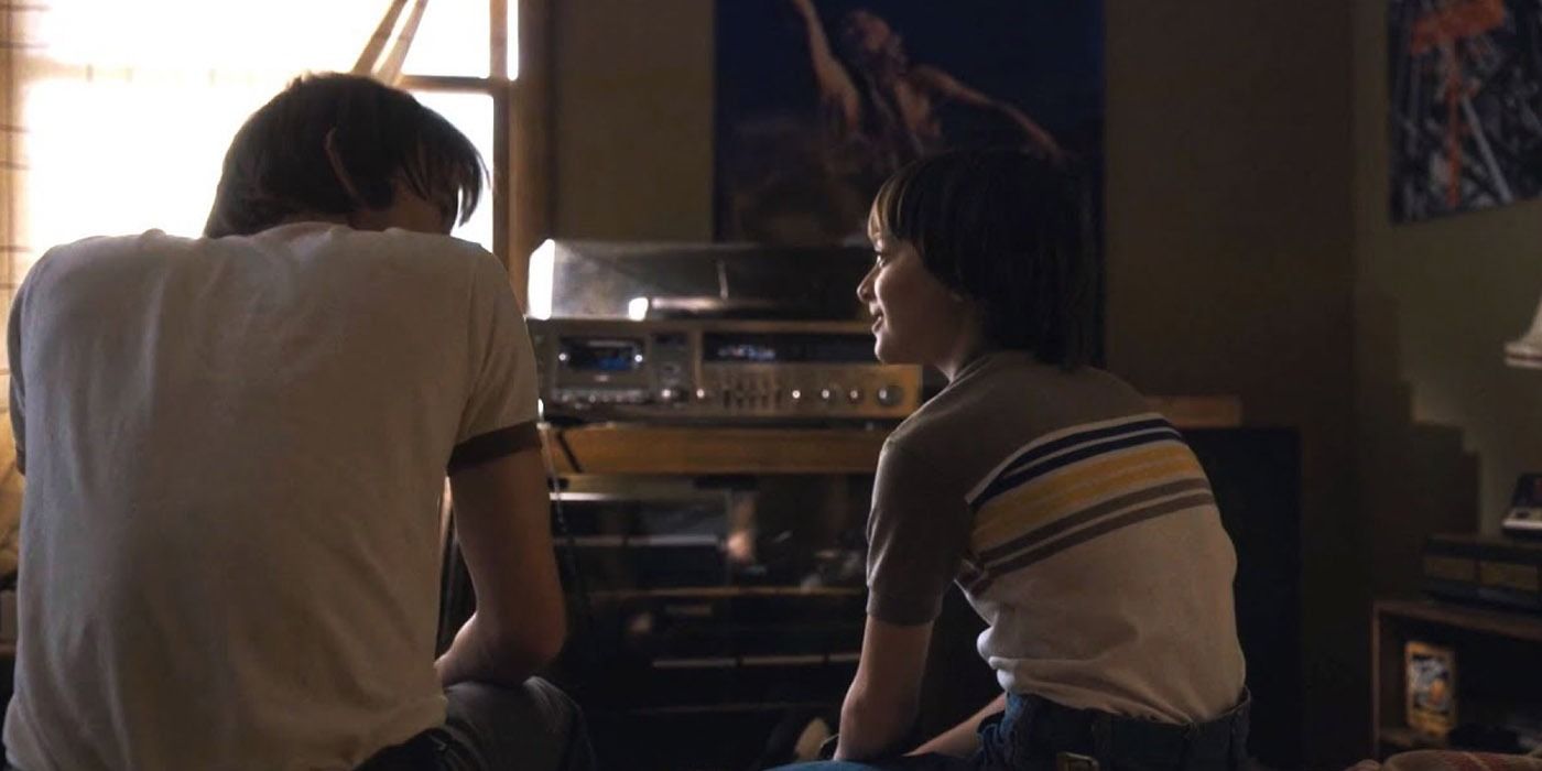 Will and Jonathan Byers listening to a record with their backs to the camera on Stranger Things