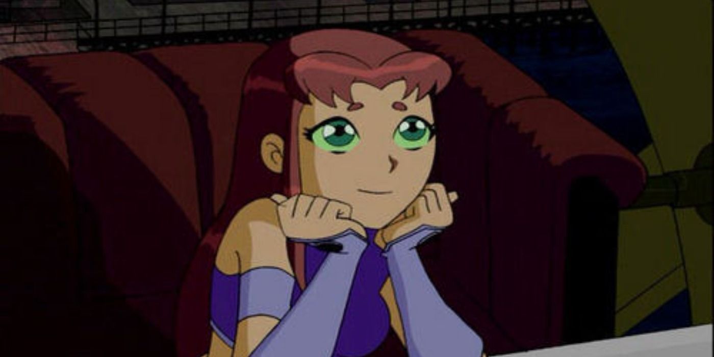 Starfire sitting at a table with her chin in her hands in Teen Titans