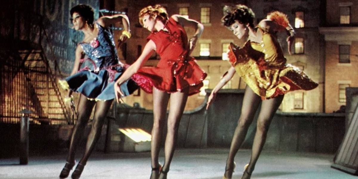 Three women in the air dancing in still from Sweet Charity.