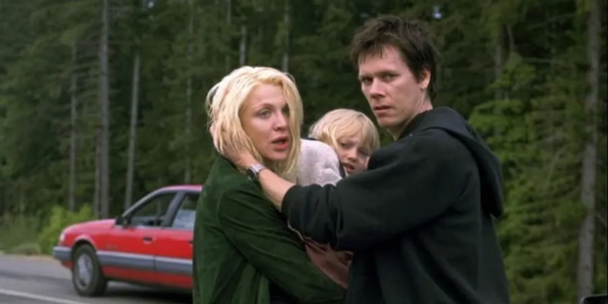 Kevin Bacon, Courtney Love, and child holding each other in Trapped.