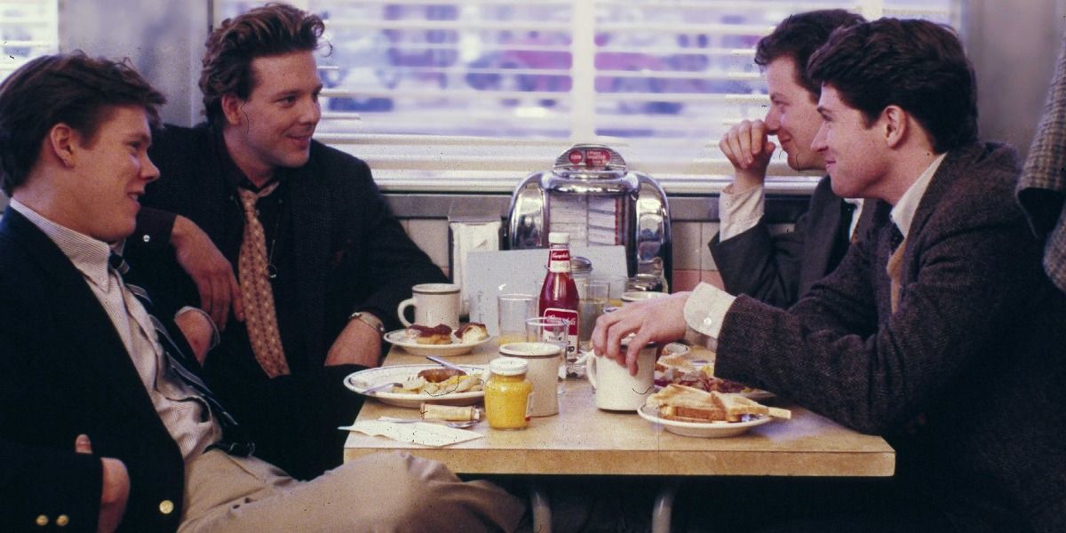 A still from Diner where four men are seated at a table in a diner.