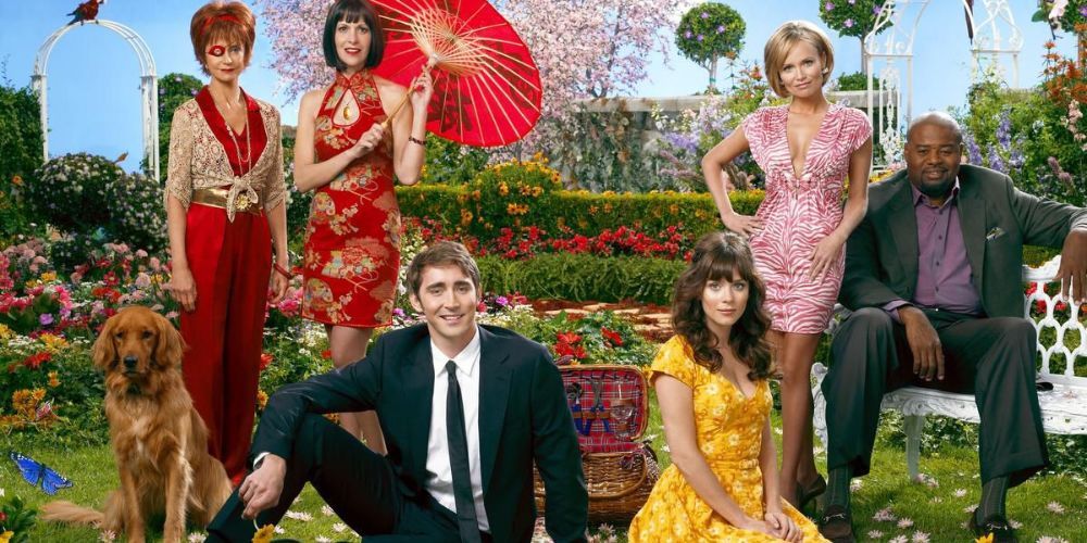 The cast of Pushing Daisies pose in a storybook-like garden setting