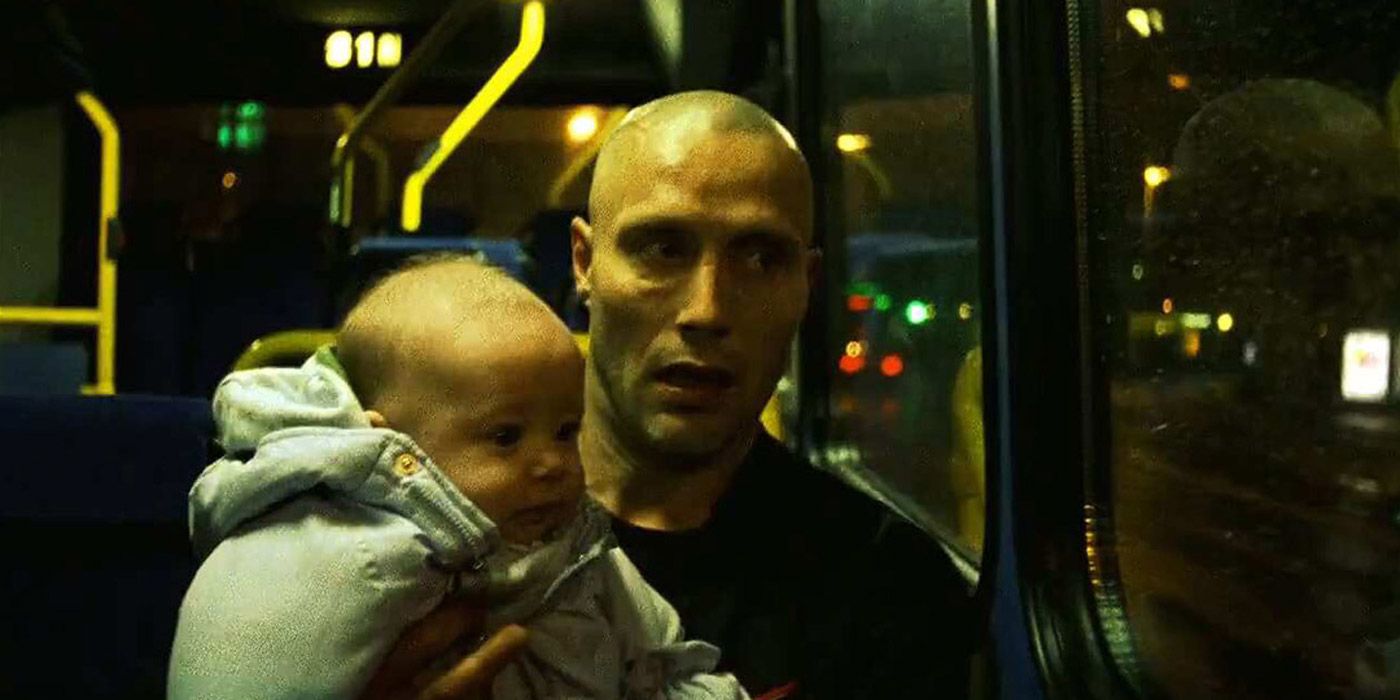 Mads Mikkelsen as Tonny carrying his baby while riding the bus in Pusher II