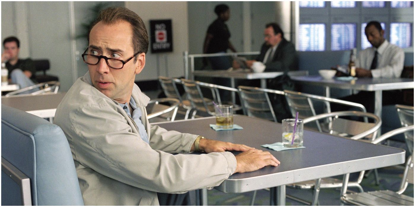 Roy sitting at a table, looking worried in Matchstick Men