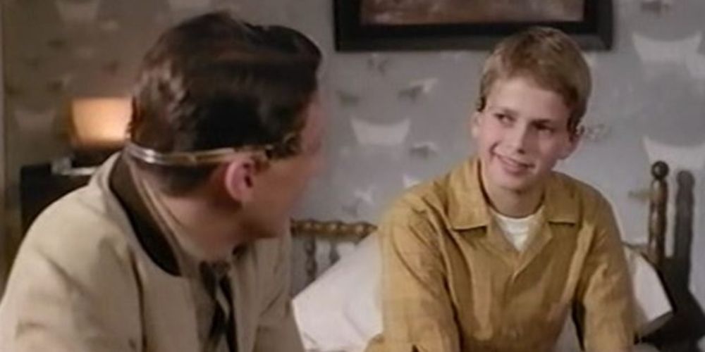 Sean Astin and Hayden Christensen sitting on a bed
