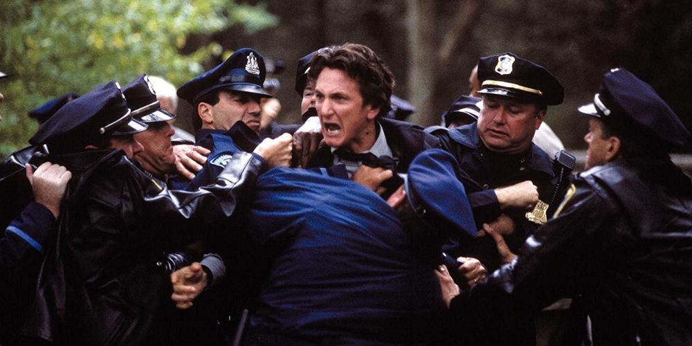 Jimmy is held back by the police in Mystic River