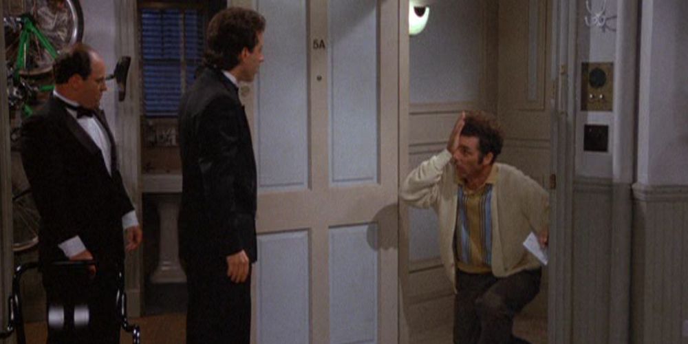 Kramer holds his eye and sits on a knee at Jerry's door in Seinfeld