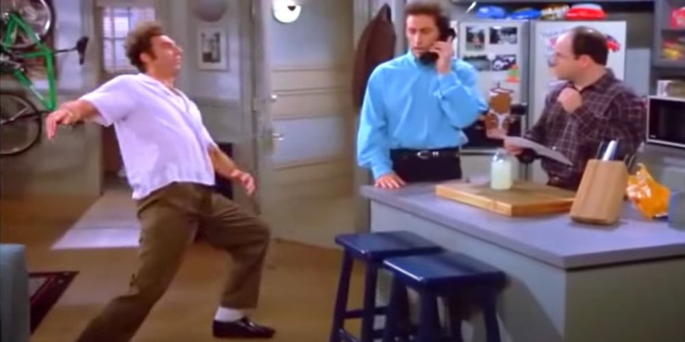 Kramer surfs across Jerry's floor in Seinfeld