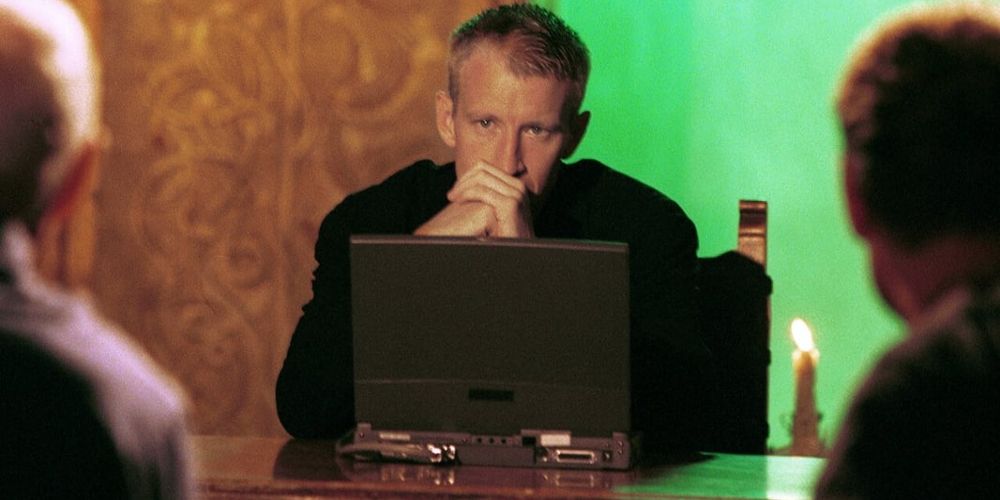 Anderson Cooper sits behind a computer on The Mole