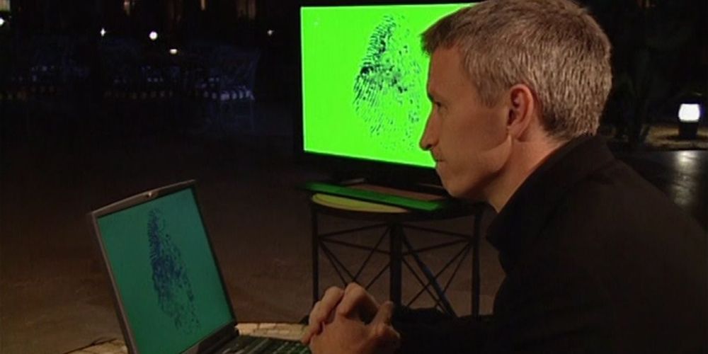 Anderson works on a computer on The Mole