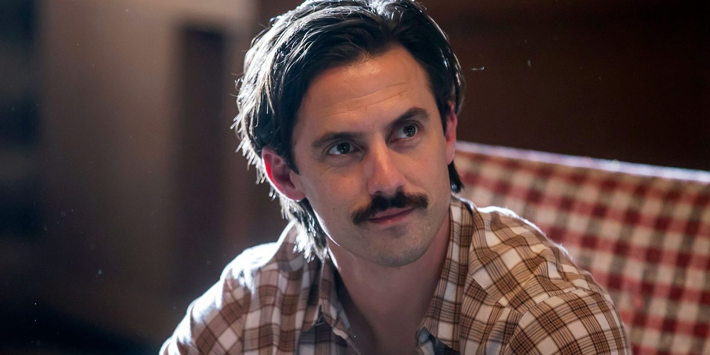 Jack sitting in a plaid shirt with a moustache in a flashback scene from This is Us.