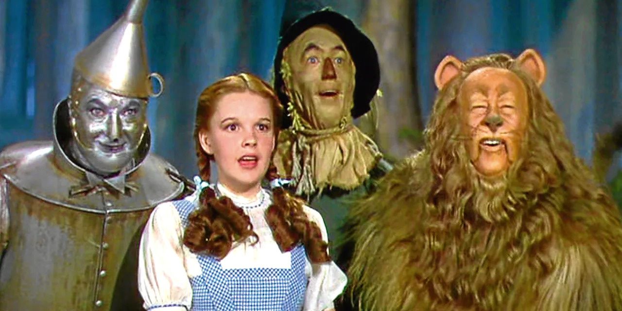 The Tinman, Dorothy, Scarecrow and Cowardly Lion standing side by side in shock.