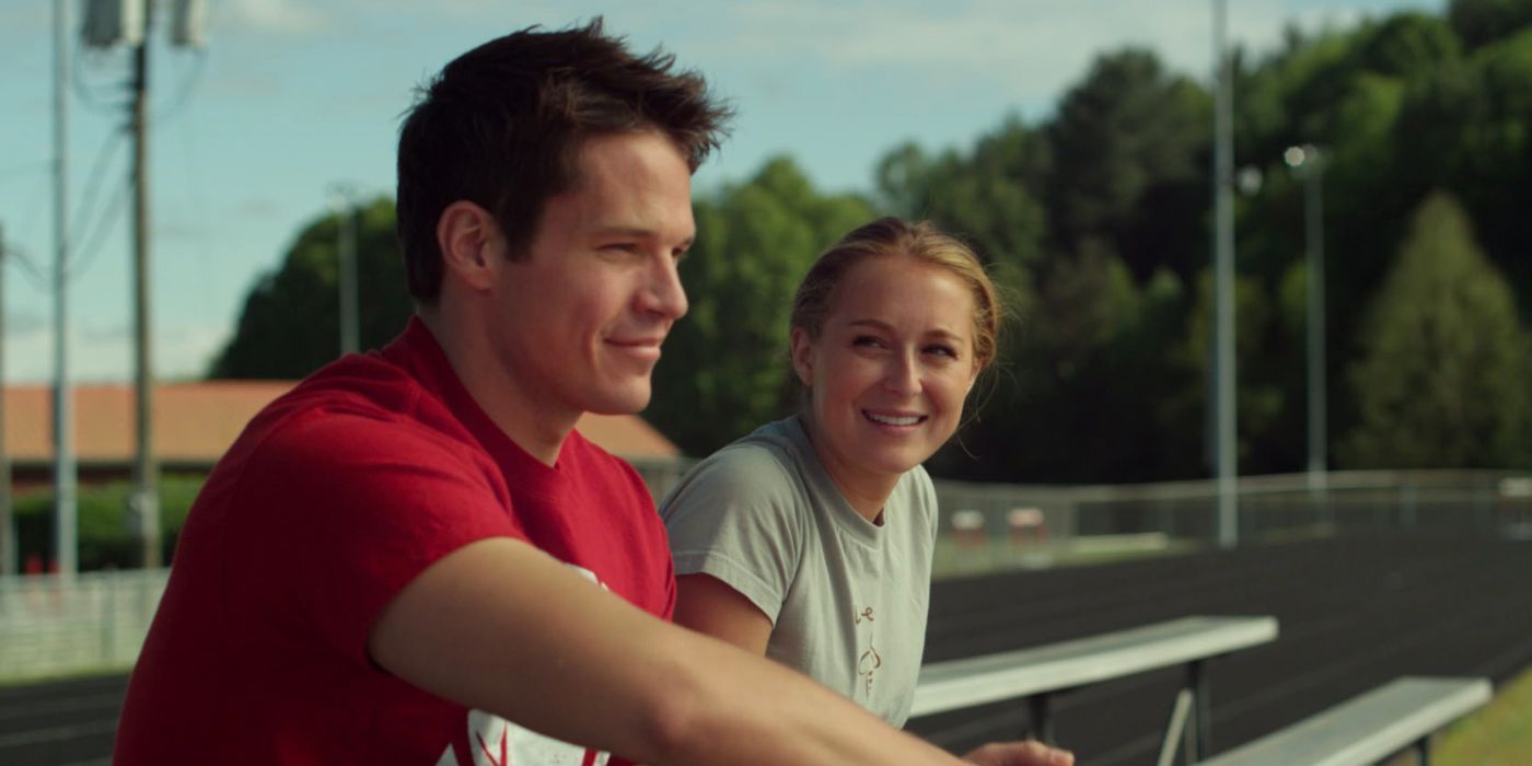 A man and woman sitting on bleachers in 23 Blast