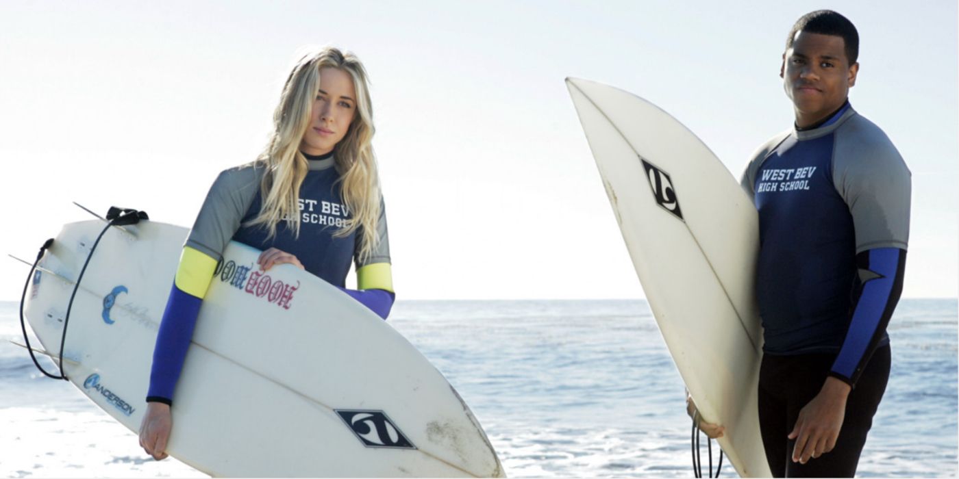 Ivy and Dixon holding surfboards on 90210.