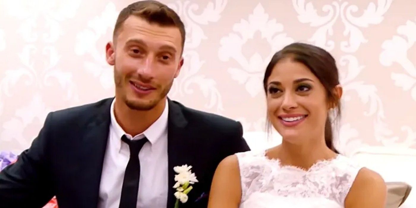 Alexei and Loren Brovarnik of 90 Day Fiance closeup on their wedding day with wallpaper background