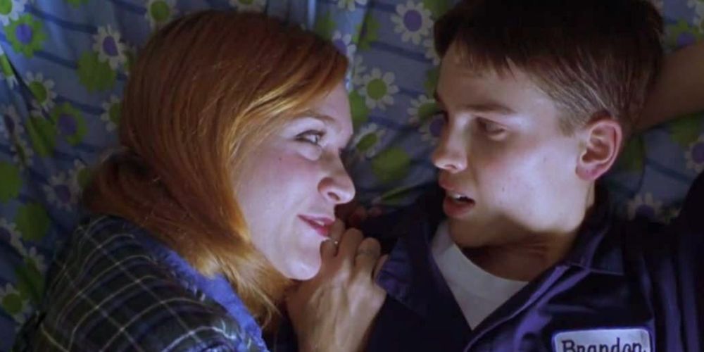 Hilary Swank as Brandon Teena cuddles up with his girlfriend 