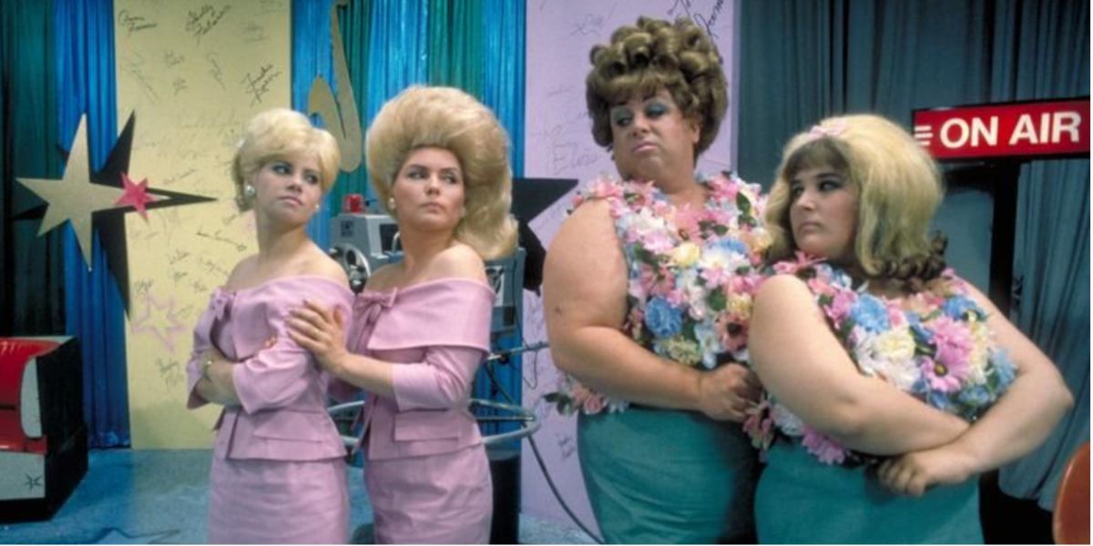 The Tussles and the Turnblads with their backs to each other in Hairspray.