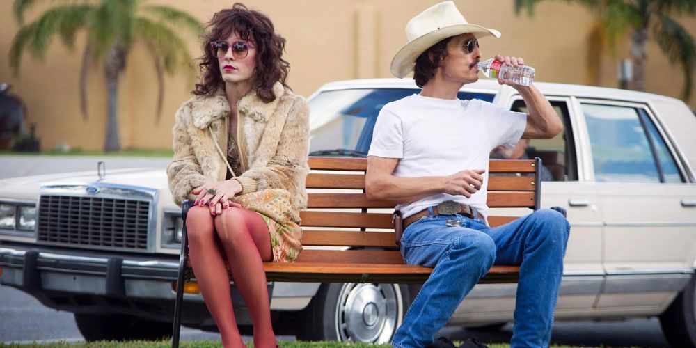 McConaughey sits next to Jared Leto (who is playing a trans woman) on a park bench