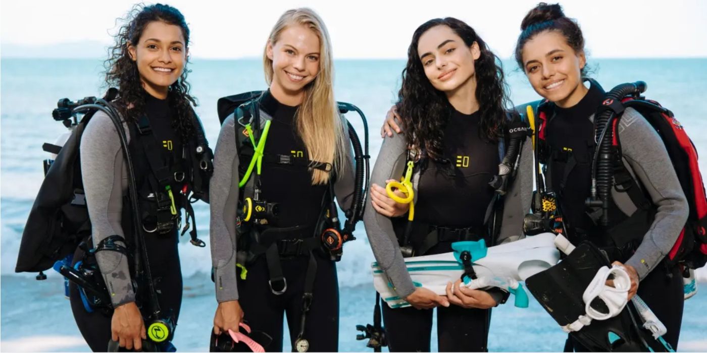 Stevie, Lauren, Anna, and Maddie from Netflix's Dive Club, wearing scuba gear.