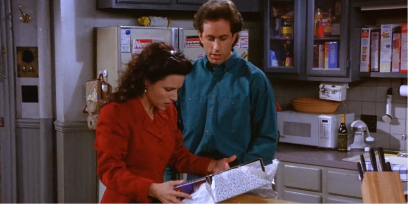 Elaine inspects a gift with Jerry standing beside her in Seinfeld