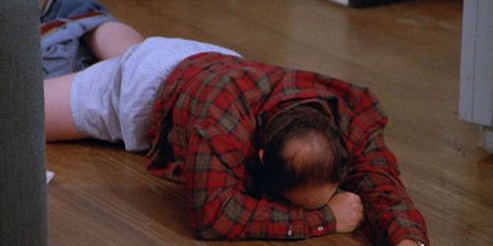 George Lying on the floor of Jerry's apartment pants around ankles