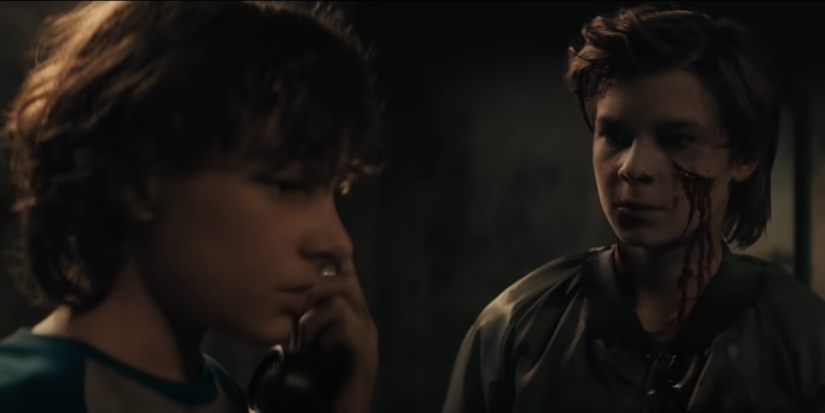 Finny standing next to the ghost of The Grabber victim Griffin in The Black Phone