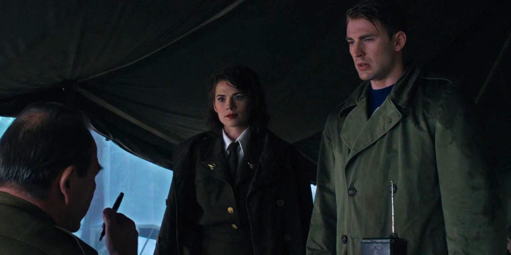 Hayley Atwell as Peggy Carter and Chris Evans as Steve Rogers stand in a tent in Captain America