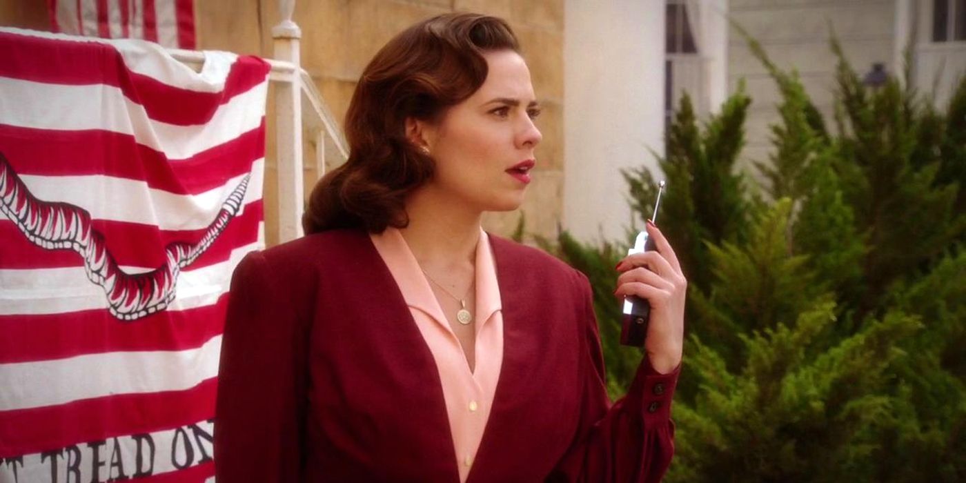 Hayley Atwell as Peggy Carter holding a walkie-talkie in Agent Carter