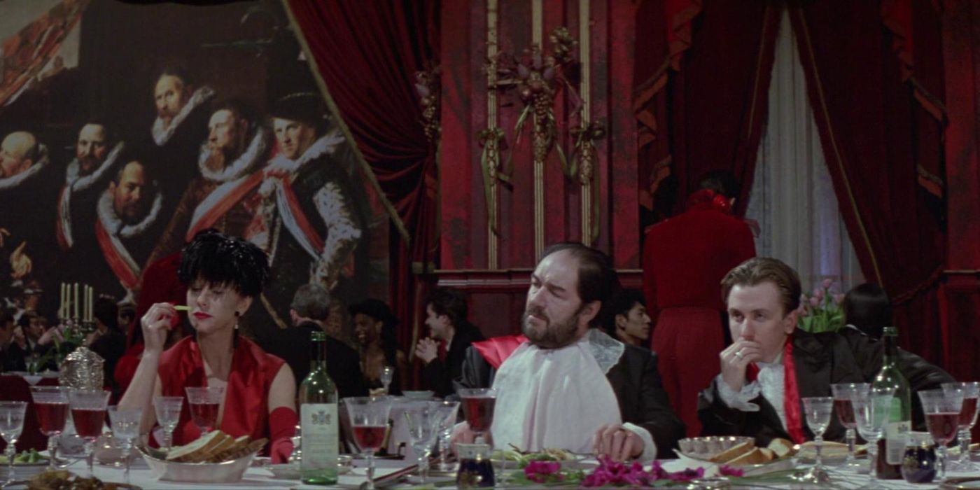 Georgina, Albert, and Mitchell at the dinner table in The Cook, The Thief, His Wife and Her Lover.