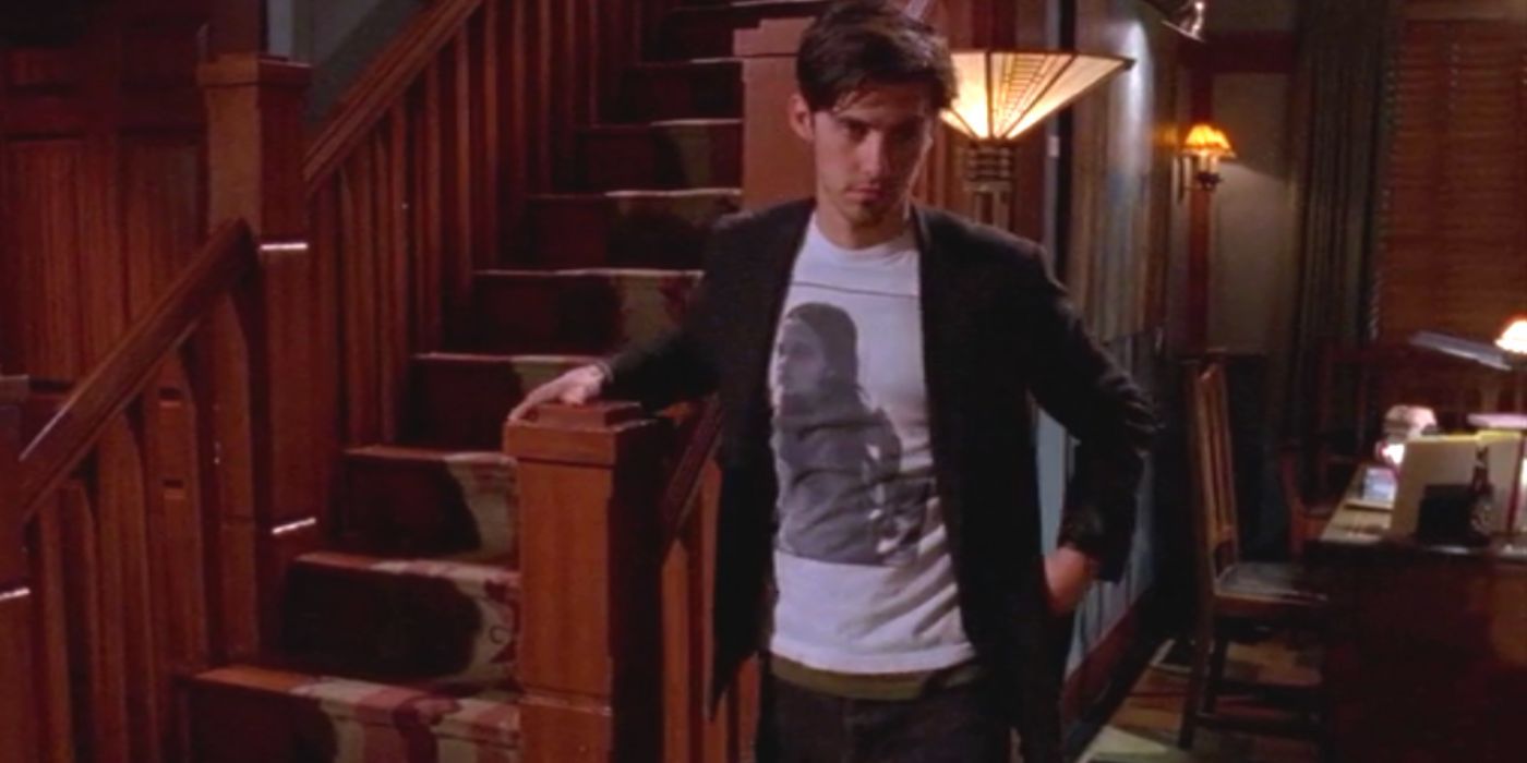 Jess stands by a stairwell at his publishing office on Gilmore Girls