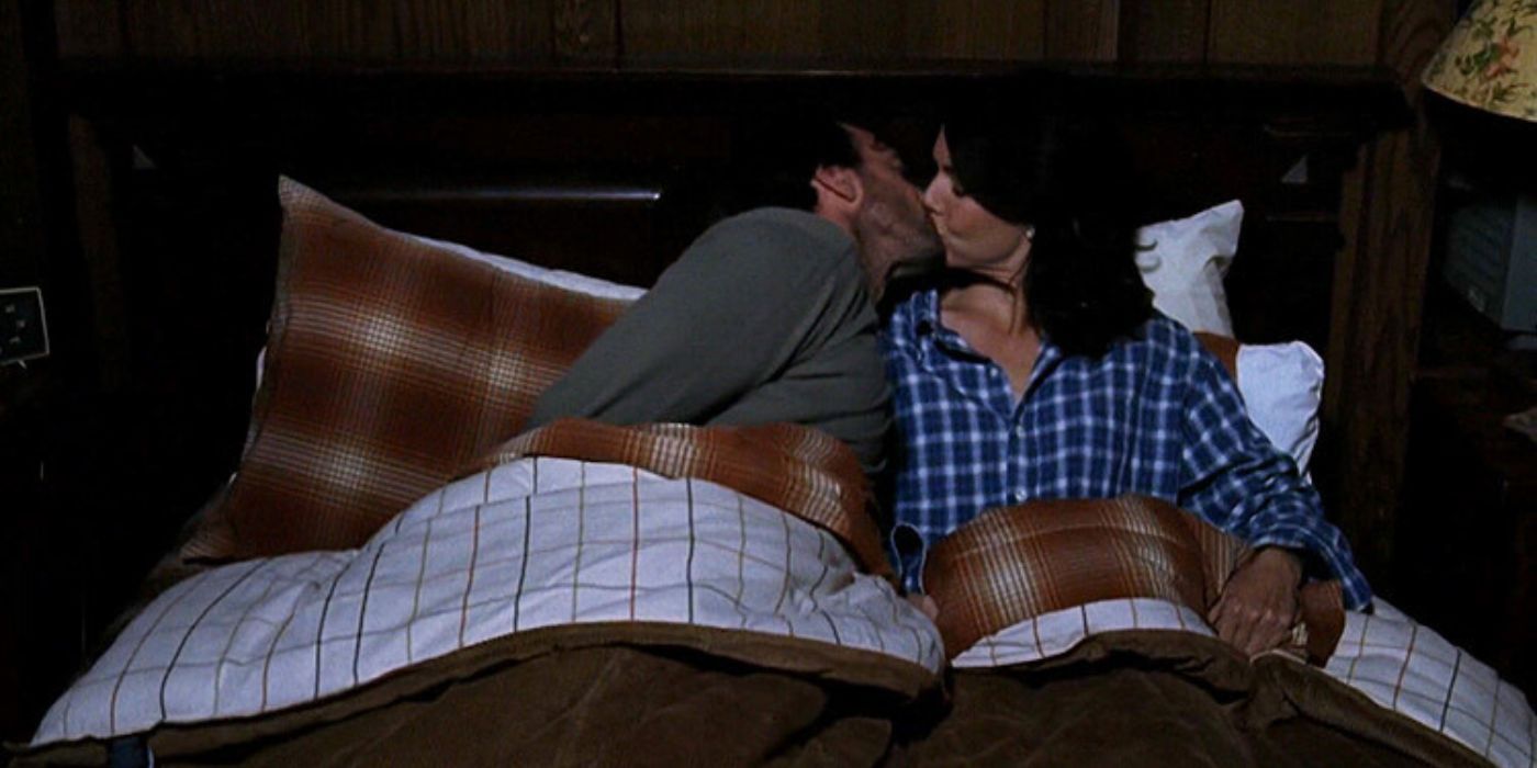 Lorelai and Luke kiss in bed on Gilmore Girls