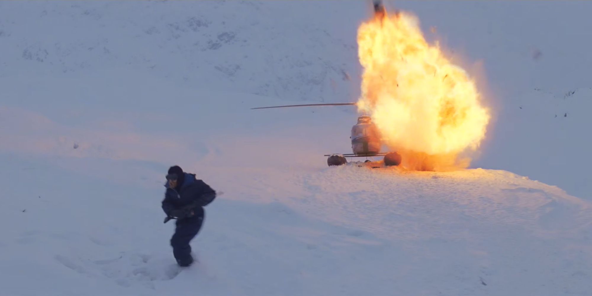 Matias dying in an explosion while Lars runs from the explosion in John Carpenter's The Thing