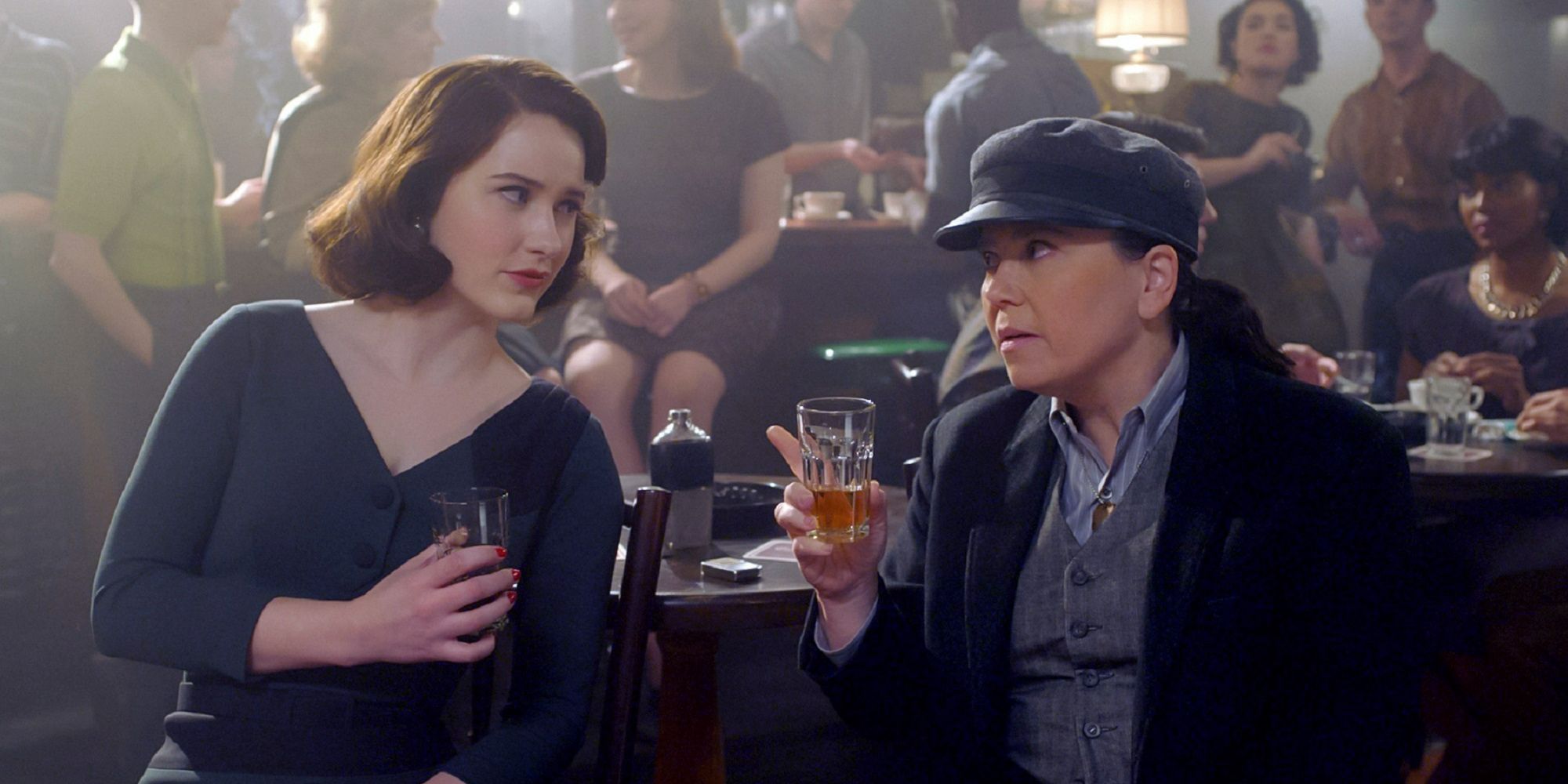 Midge and Susie sit in a bar talking in The Marvelous Mrs Maisel Season 4
