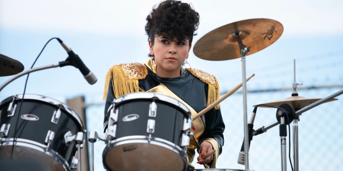 Noemi Gonzalez as Suzette in Selena playing the drums