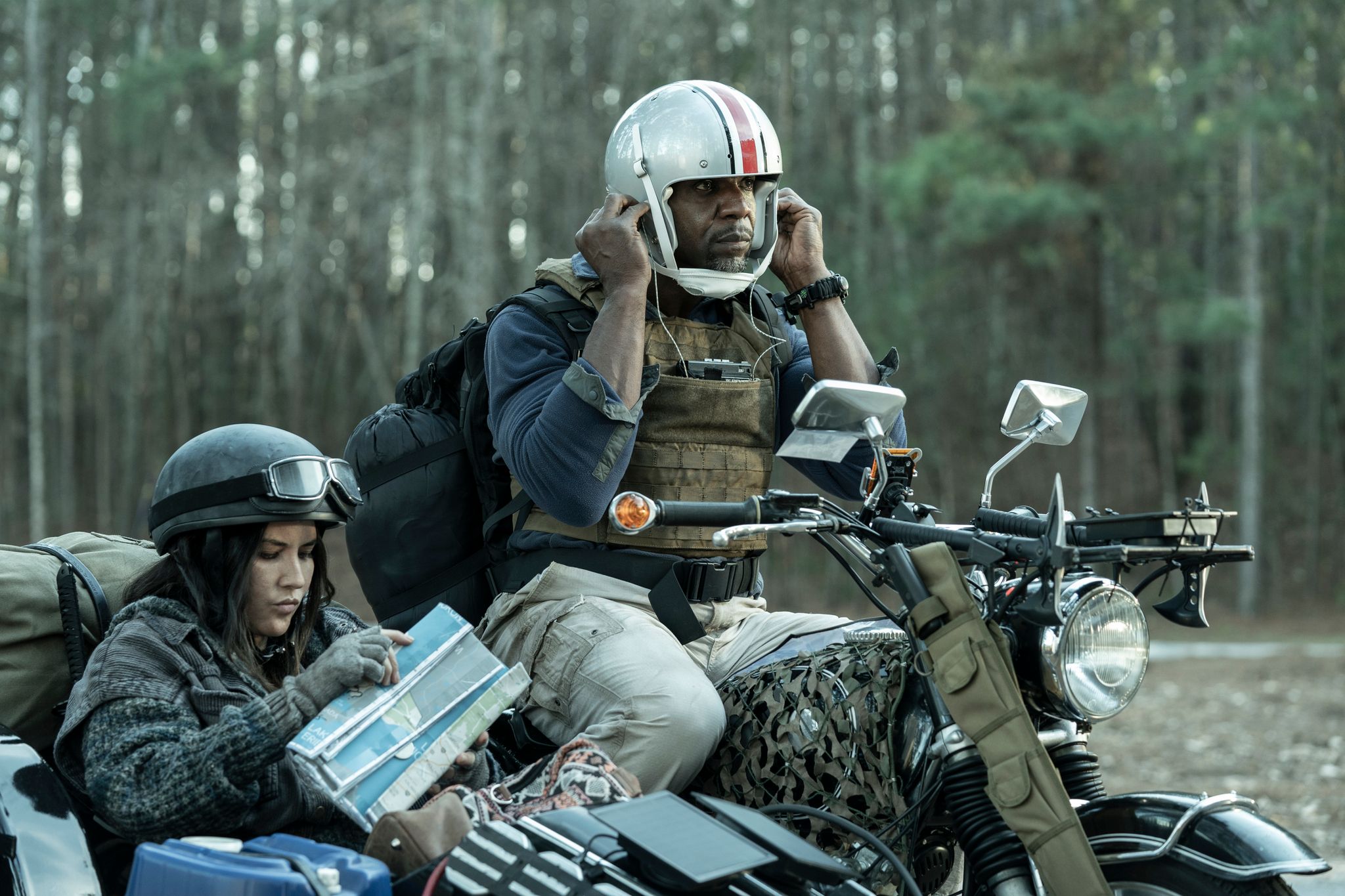 Terry Crews as Joe and Olivia Munn as Evie in character in Tales of the Walking Dead getting set to ride off somewhere on a motorcycle with a sidecar