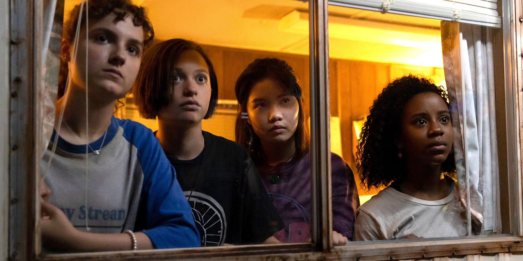 KJ, Mac, Erin and Tiffany staring out a window in Paper Girls