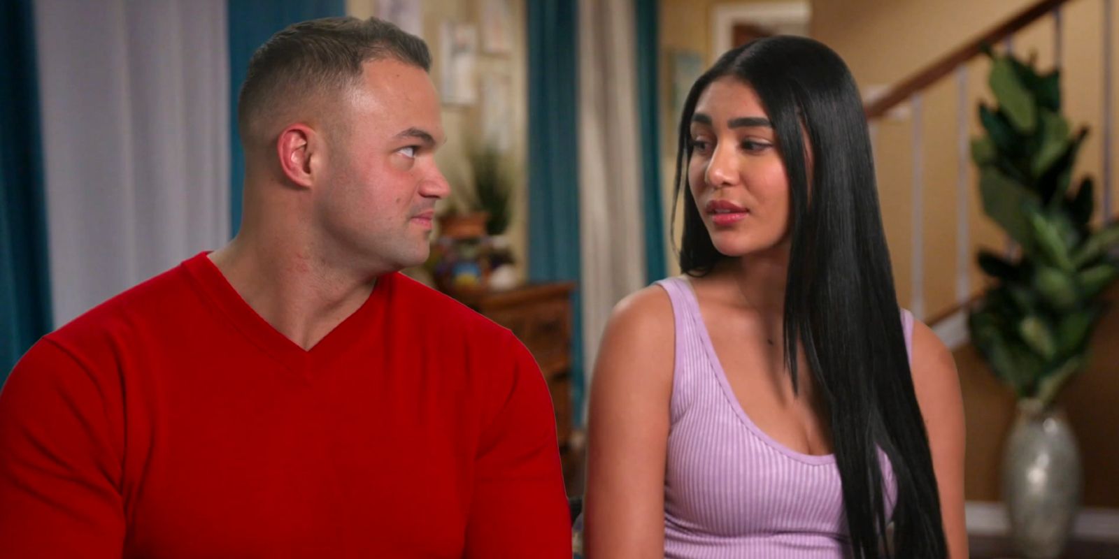 Patrick and Thaís looking at each other while talking to the camera in 90 Day Fiancé.