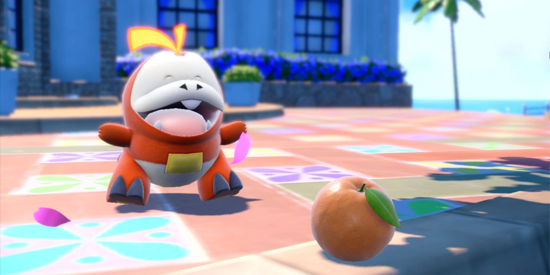 Fuecoco smiling while standing in front of an apple in Pokémon Scarlet and Violet.