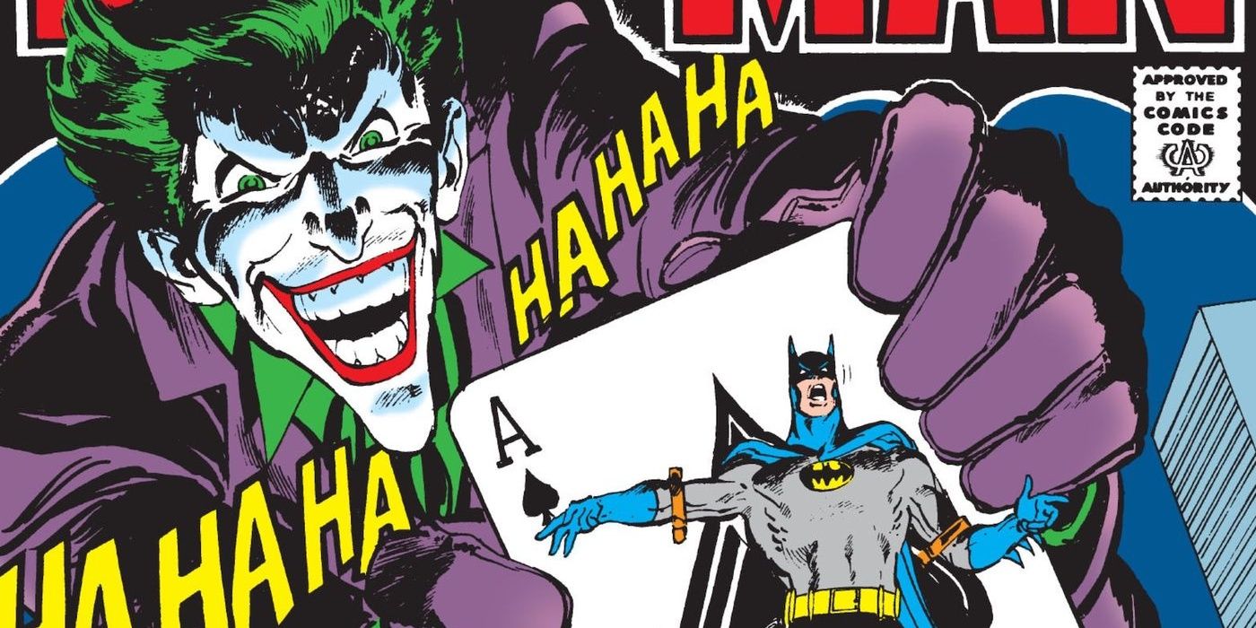 Joker holding up a Batman ace card.
