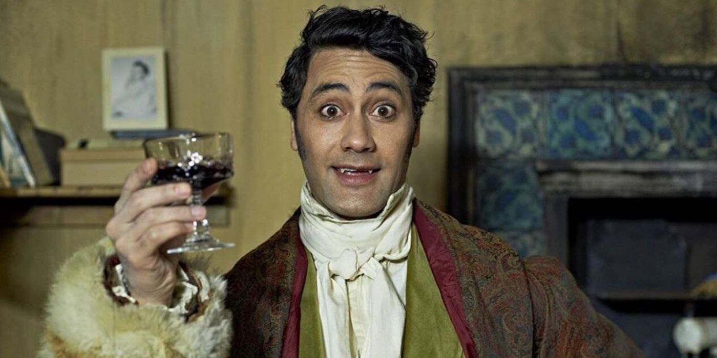 Viago holds up a glass of wine in What We Do in the Shadows