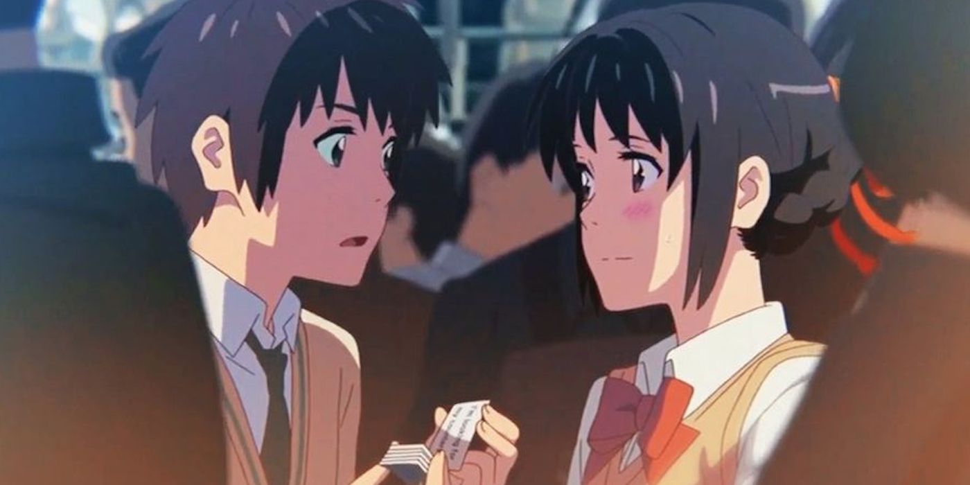 Taki and Mitsuha in Tokyo smiling at one another