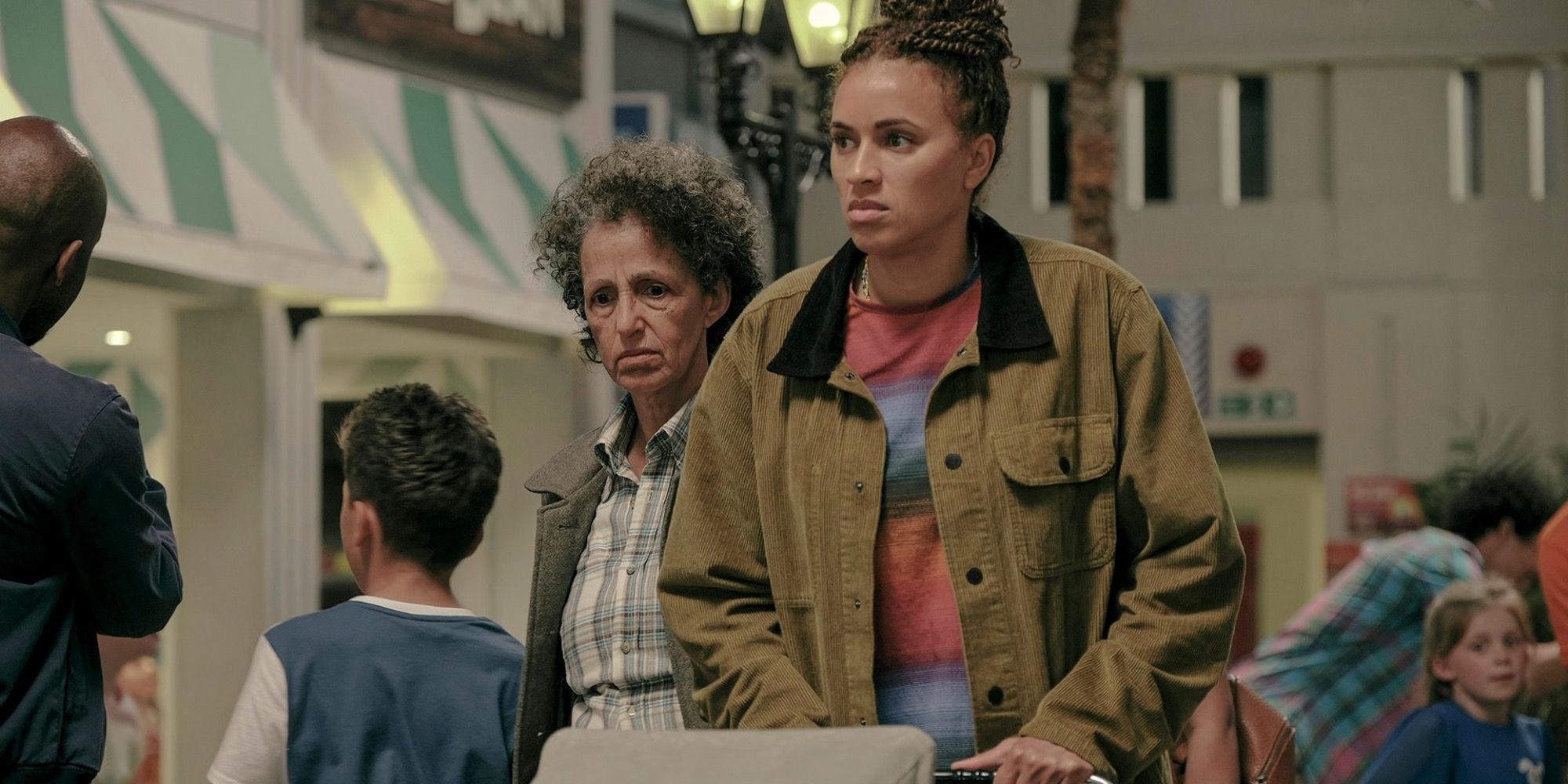 Image of Tash pushing the baby with Mrs. Eaves following behind in The Baby