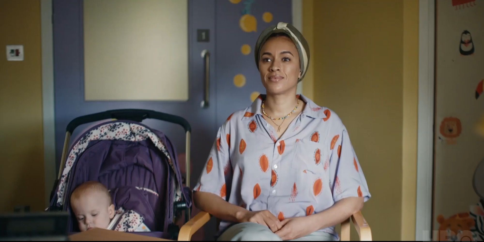 Image of Tash sitting next to the baby in a stroller