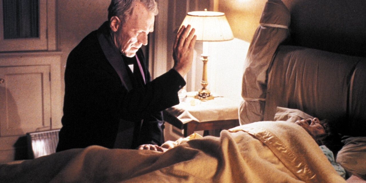 A priest blessing the posessed child in her bed