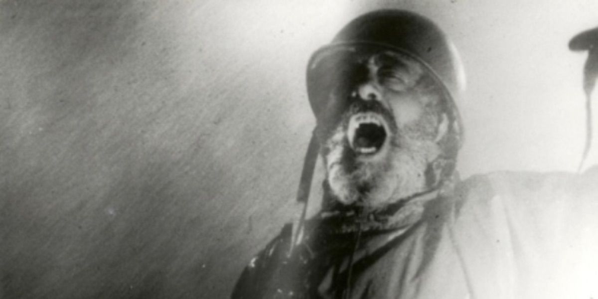 A man wearing a military helmet screams inside of fog from The Noah